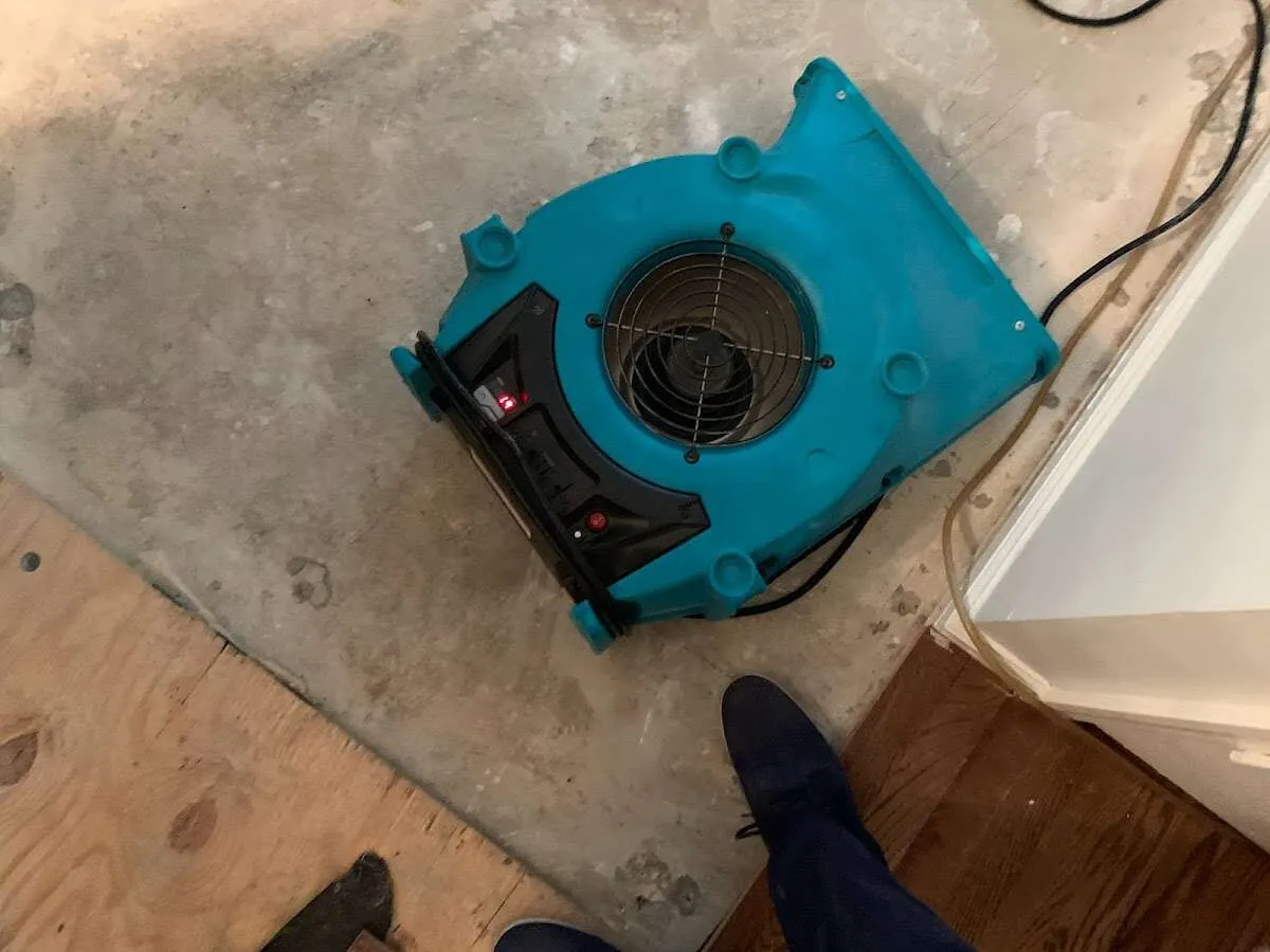 Air mover drying subfloor during Commercial Water Damage Restoration in Beloit